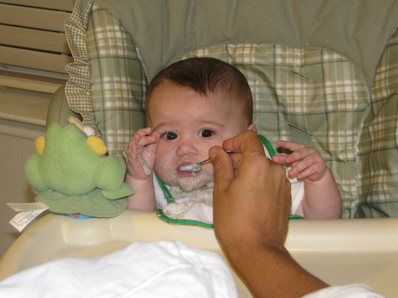DaddyFeedsCereal2.JPG - Daddy feeds me a little cereal.
