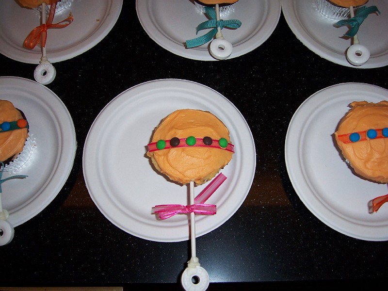 Picture_382.jpg - Rattle cupcakes by miss Jessica Newell for the baby shower at Children's. They're orange flavored.
